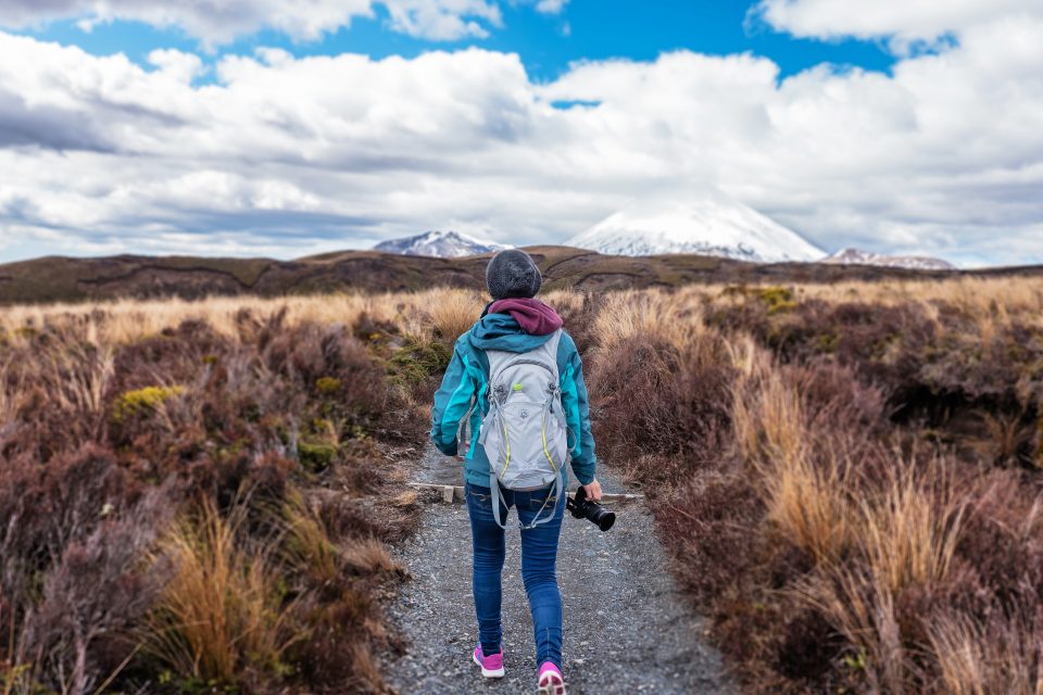 A woman hiking through fields