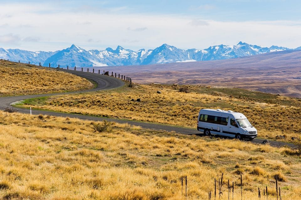 A mini bus driving through the mountains