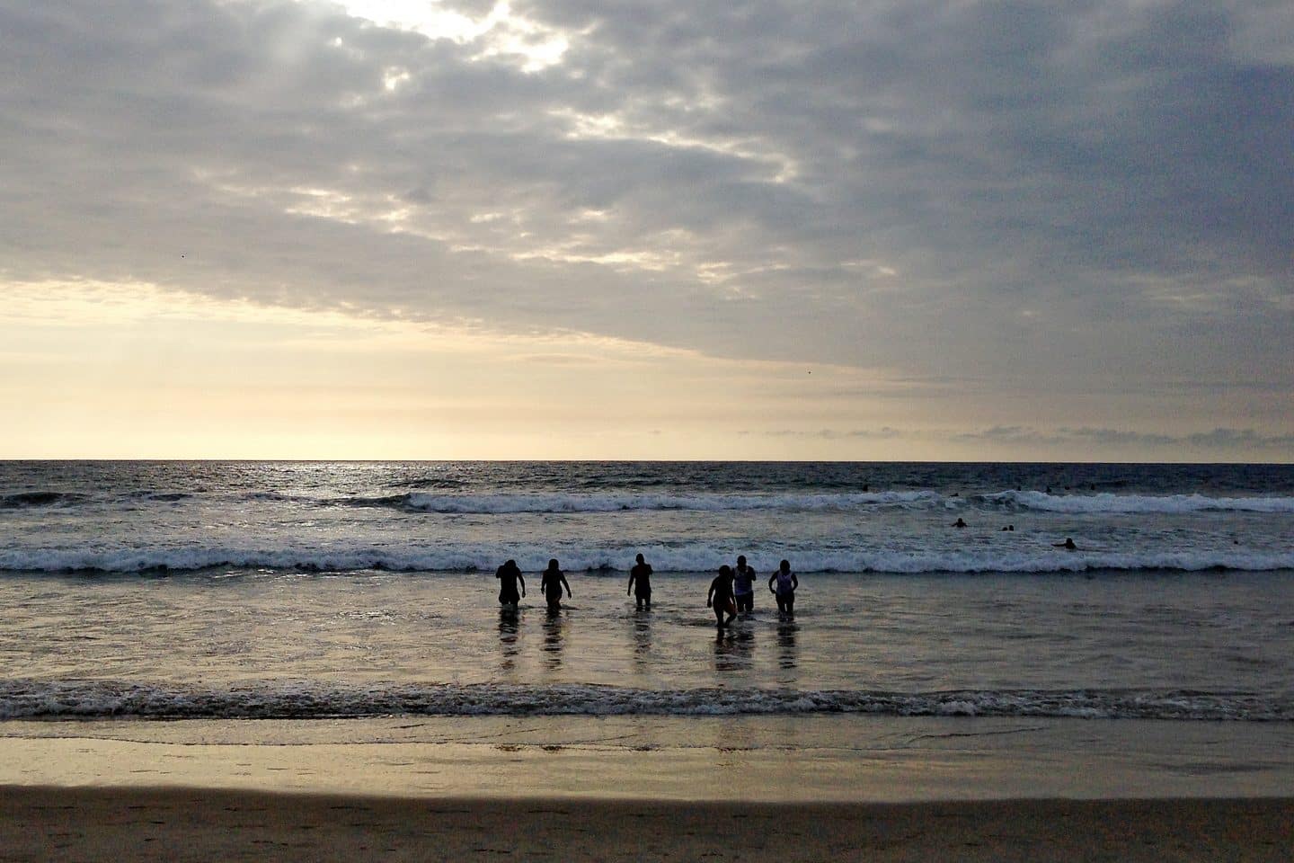 Silhouettes of people in the sea