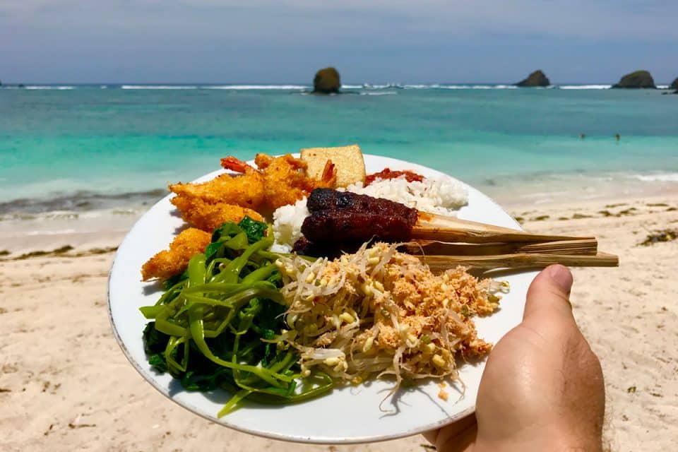 A plate of Indonesia food by the beach