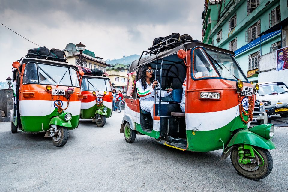 Three brightly coloured tuk tuks in India