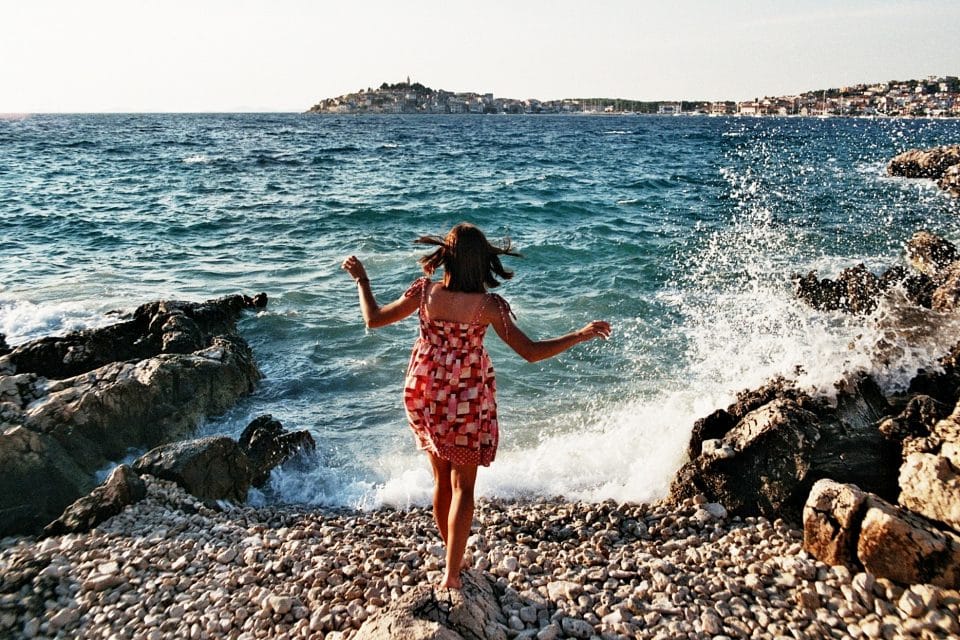A woman on a pebble beach