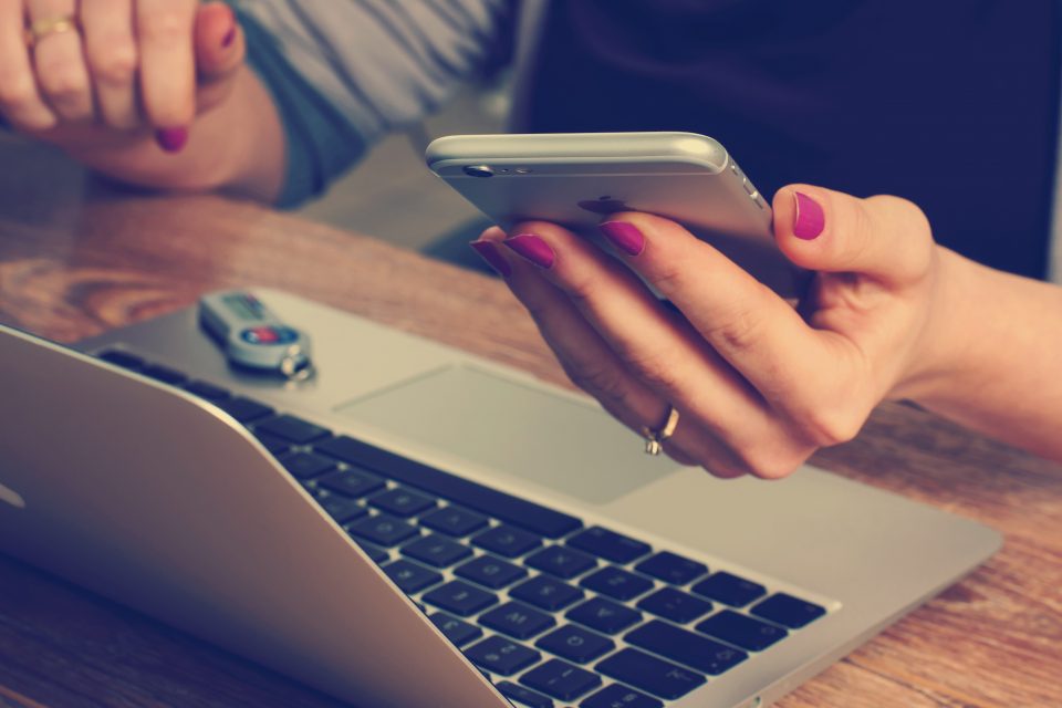 A woman, her laptop and her phone