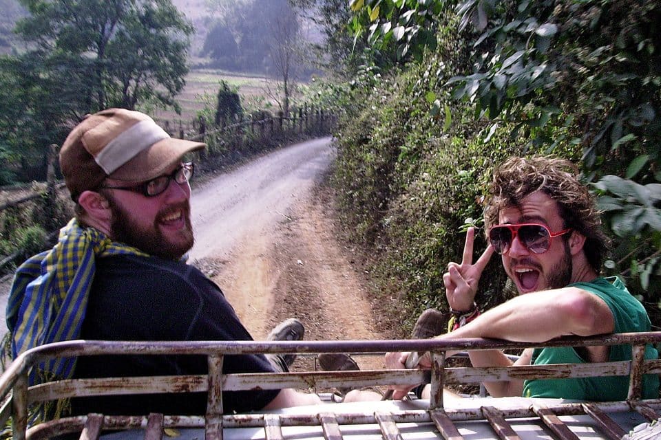 Two men posing on the back of a jeep