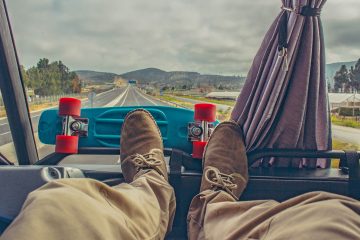 A man's feet up on the dashboard