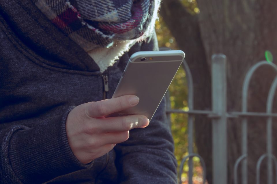 Girl holds iphone in hand