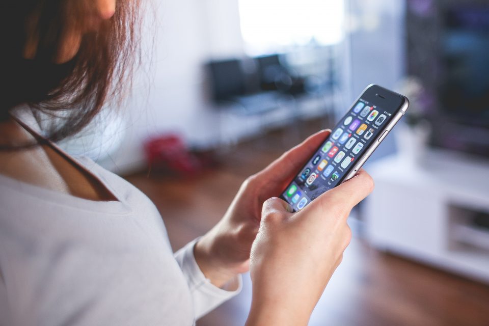 Girl looking at apps on her phone