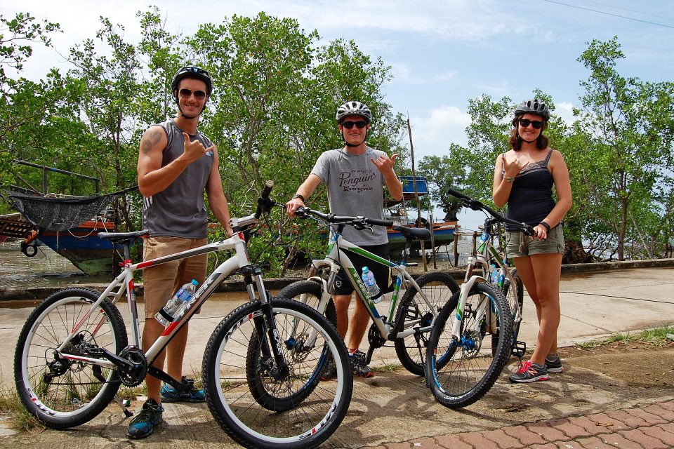 A group of people standing with their bikes