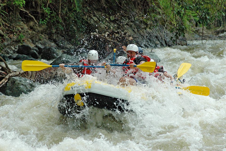 Group of people white water rafting