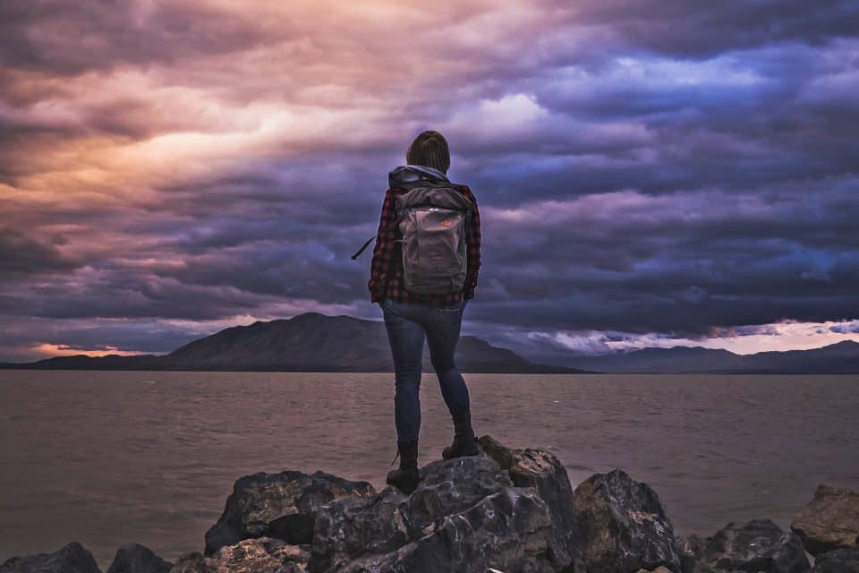 woman trekking clouds