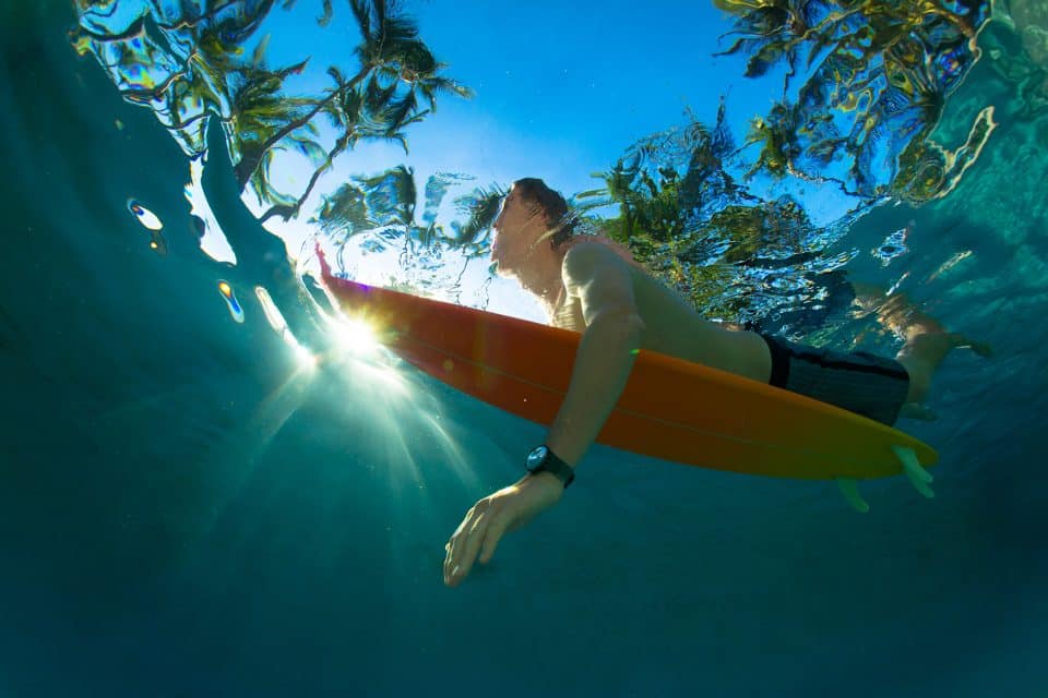 paddling out surfer