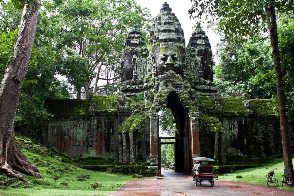 A tuk tuk driving through a temple