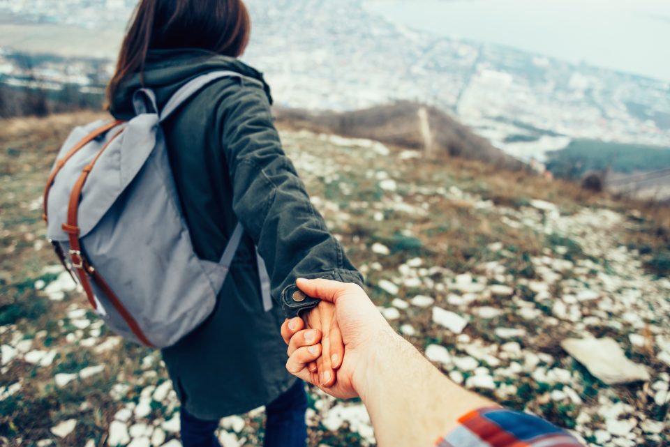 A man holding a woman's hand