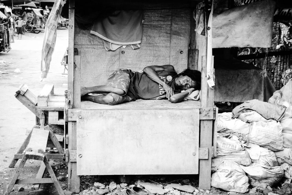 A woman sleeping in a wooden hut