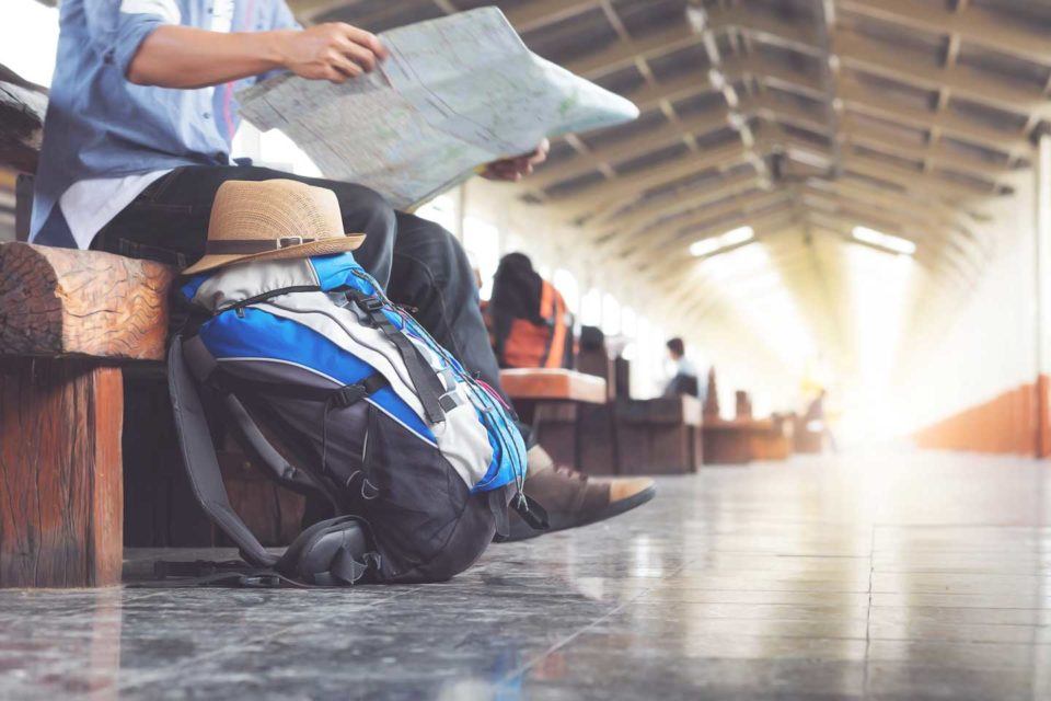 man in train station with a map