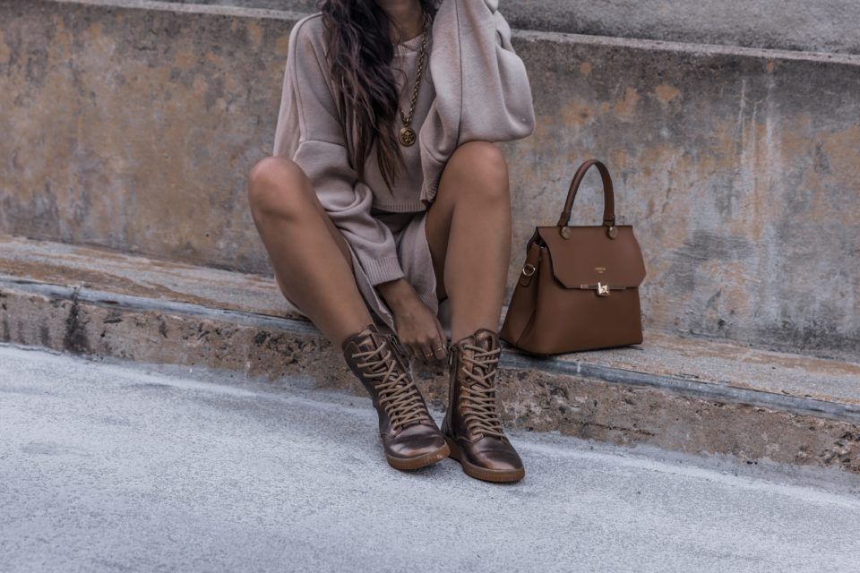 Woman sitting on steps next to her purse