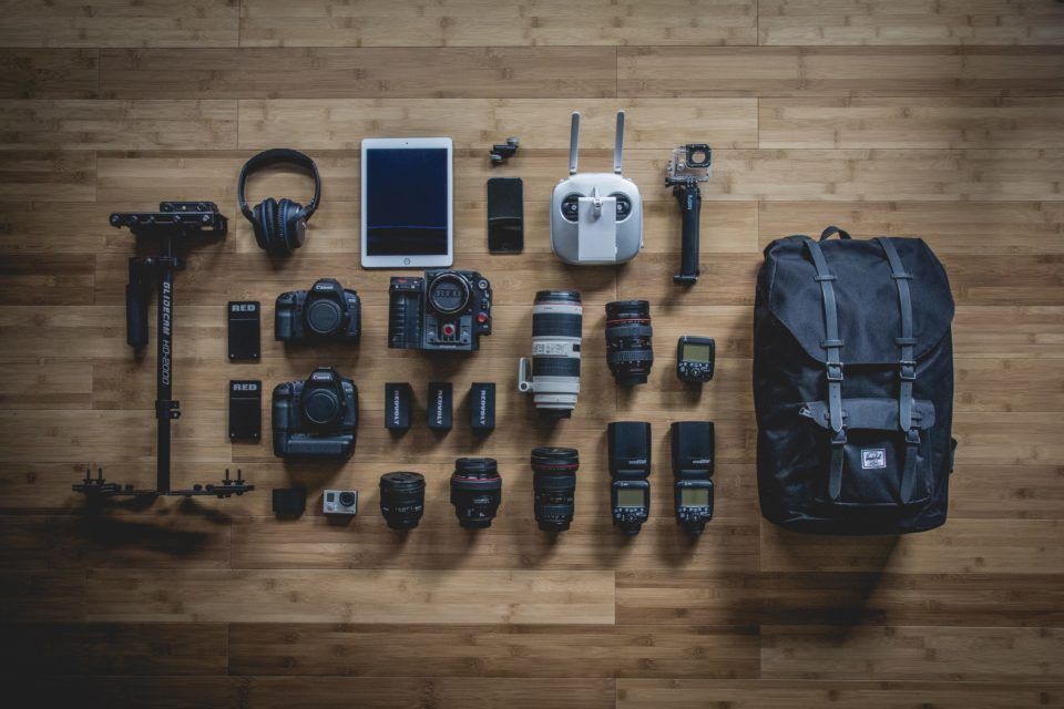 backpack surrounded by camera gear