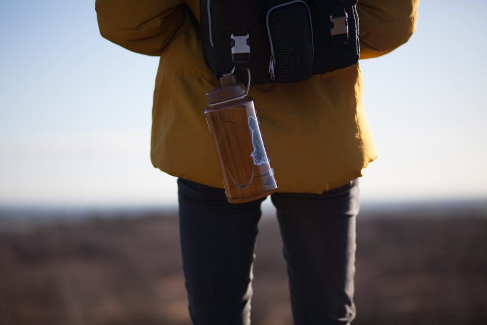 Water bottle hanging off of backpack