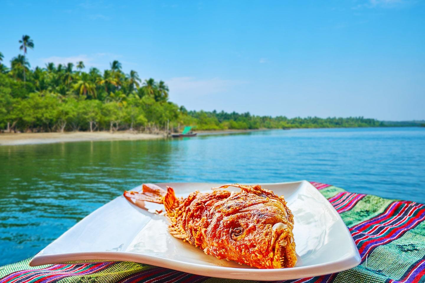 fried fish in front of ocean and beach