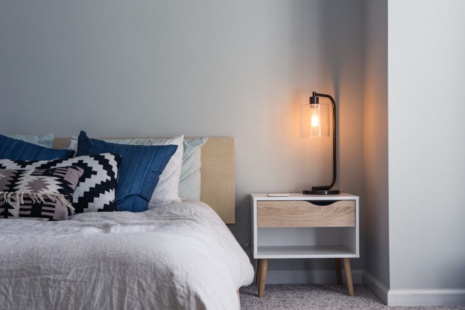 bed with side table and lamp