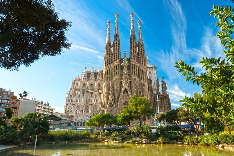 giant cathedral surrounded by trees and water