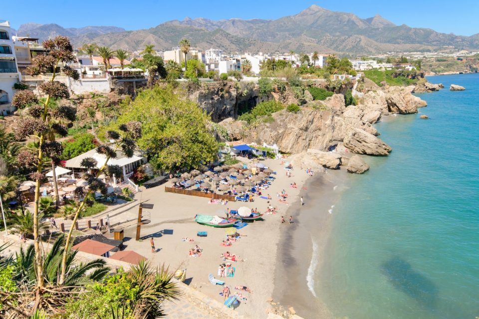 strip of sand, city and ocean at malaga beach