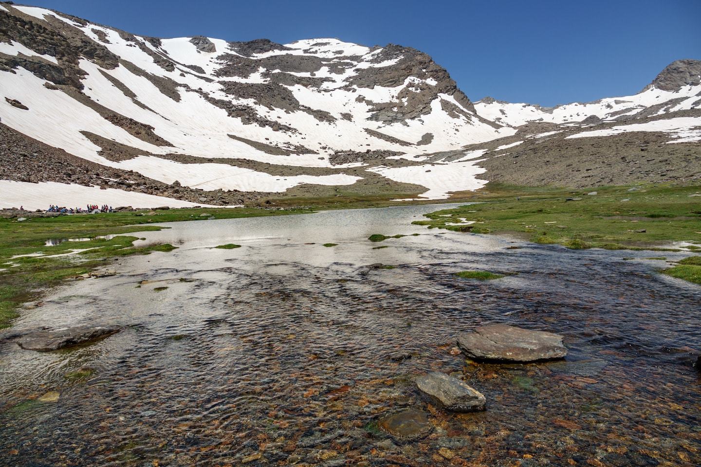 mulhacen mountain with lake in front of it spain