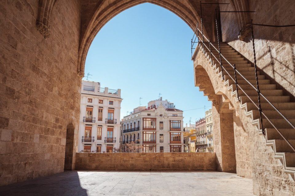 view of buildings and sky through archway
