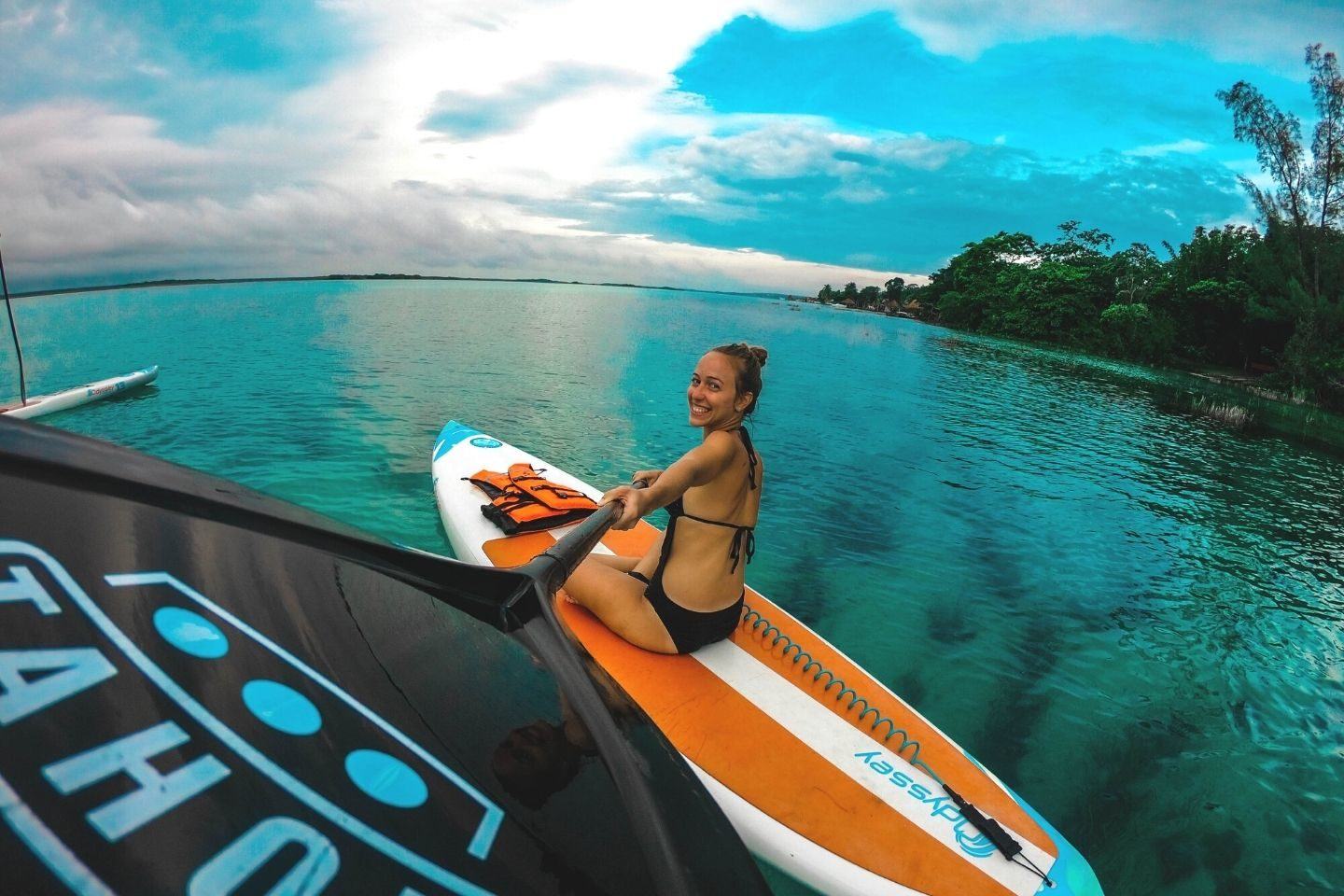 Woman sitting on paddle board