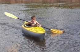 The little boy on a yellow kayak