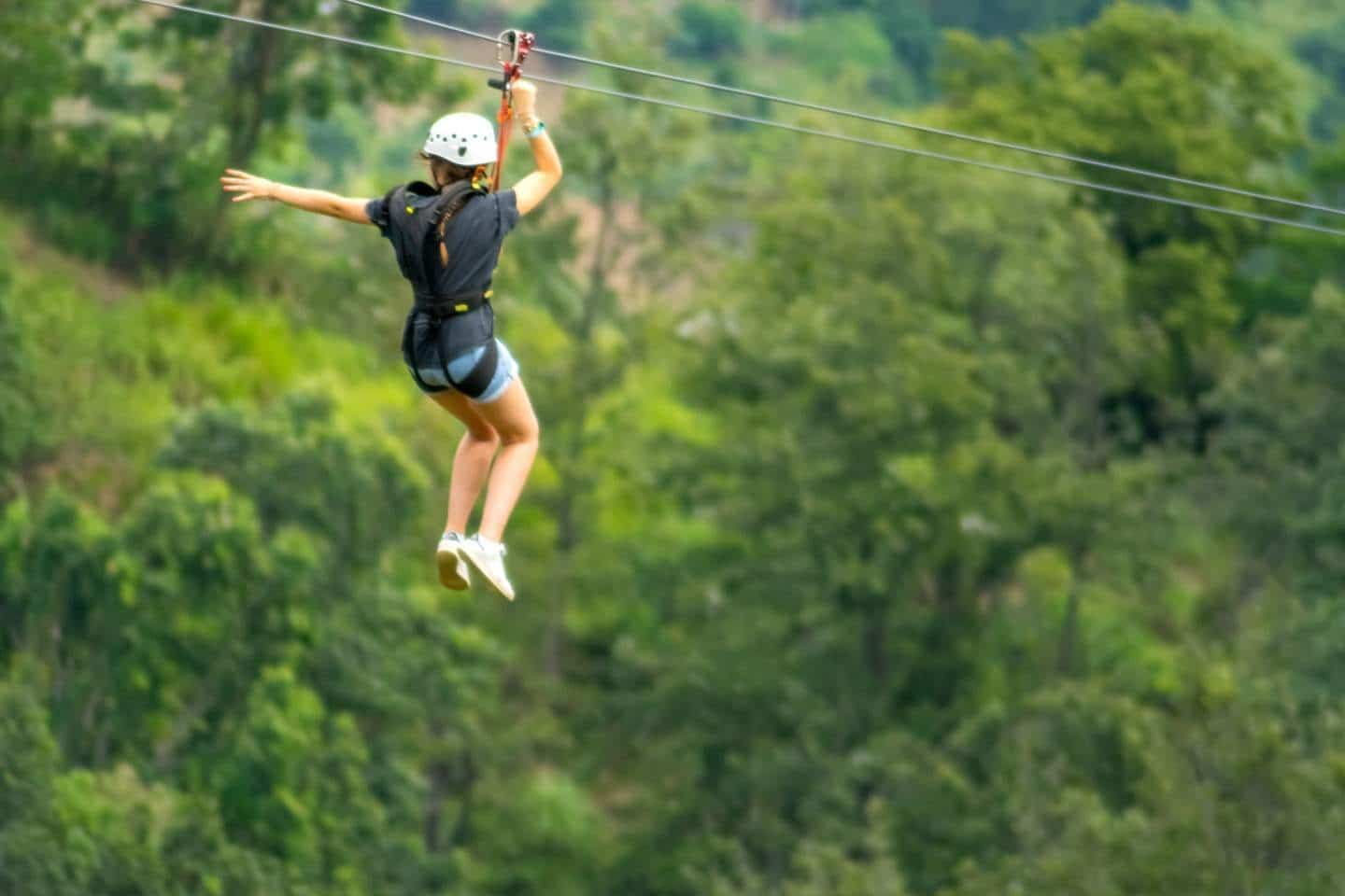 A young woman on a zipline adventure at World A+ Zipline Experience